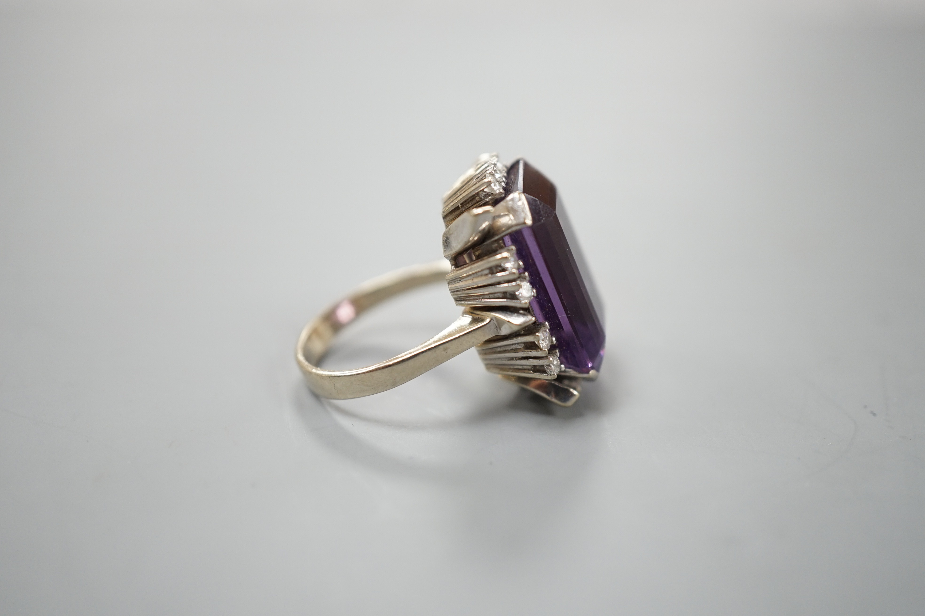 A 585 white metal emerald cut amethyst and diamond set cluster ring, size L, gross weight 11.5 grams.